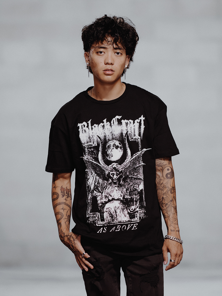 A model wearing a black cotton tee with custom Blackcraft artwork on the front and back.
