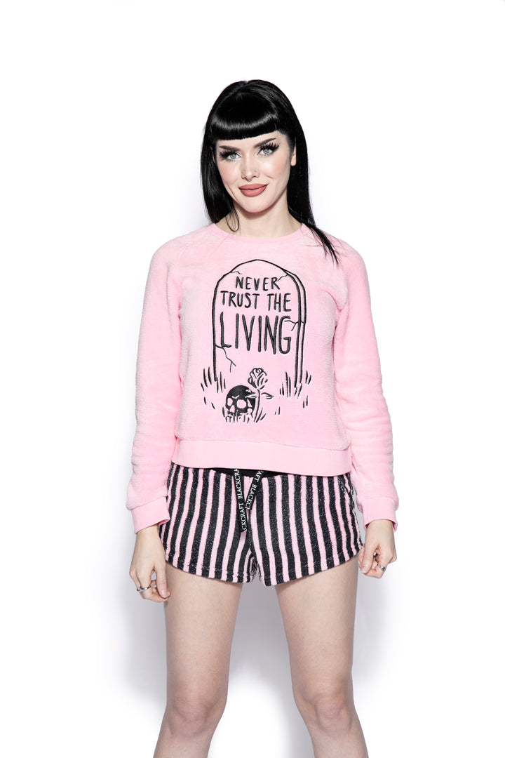 A pink and black soft fleece gothic pajama set featuring a long sleeve pullover top and micro shorts, from Blackcraft.