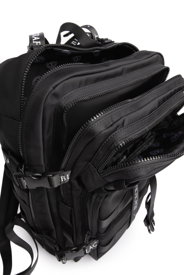 Large black nylon backpack with Blackcraft rubber logo, functional buckles, and logo strap details.