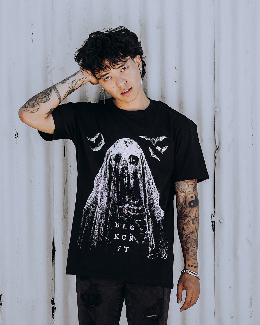 A model wearing a classic black cotton tee with custom Blackcraft artwork across the front. 