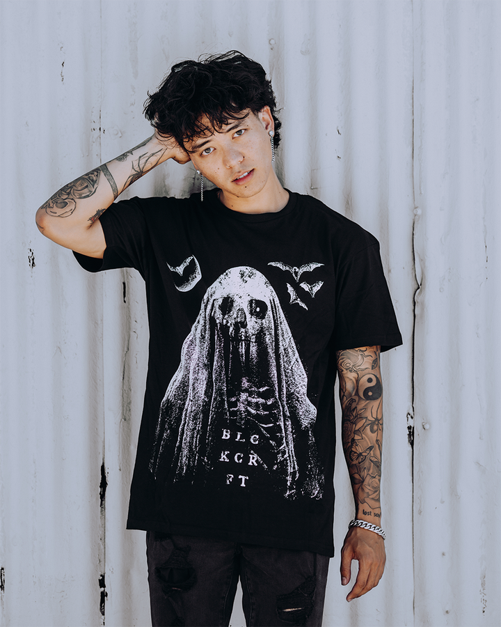 A model wearing a classic black cotton tee with custom Blackcraft artwork across the front. 
