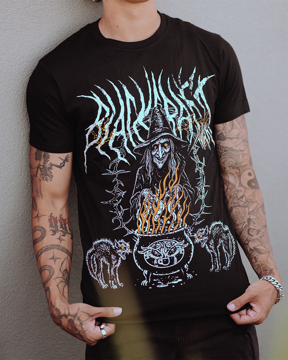 A model wearing a classic black cotton tee with custom Blackcraft artwork across the front. 