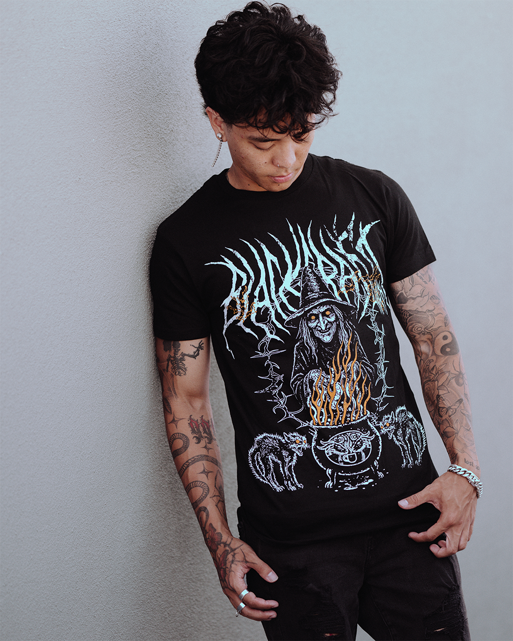 A model wearing a classic black cotton tee with custom Blackcraft artwork across the front. 