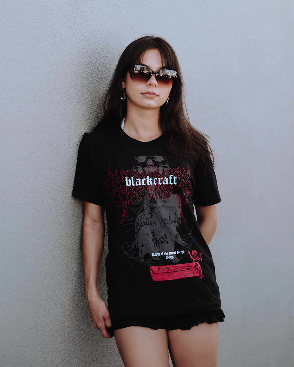 A model wearing a classic black cotton tee with custom Blackcraft artwork across the front. 