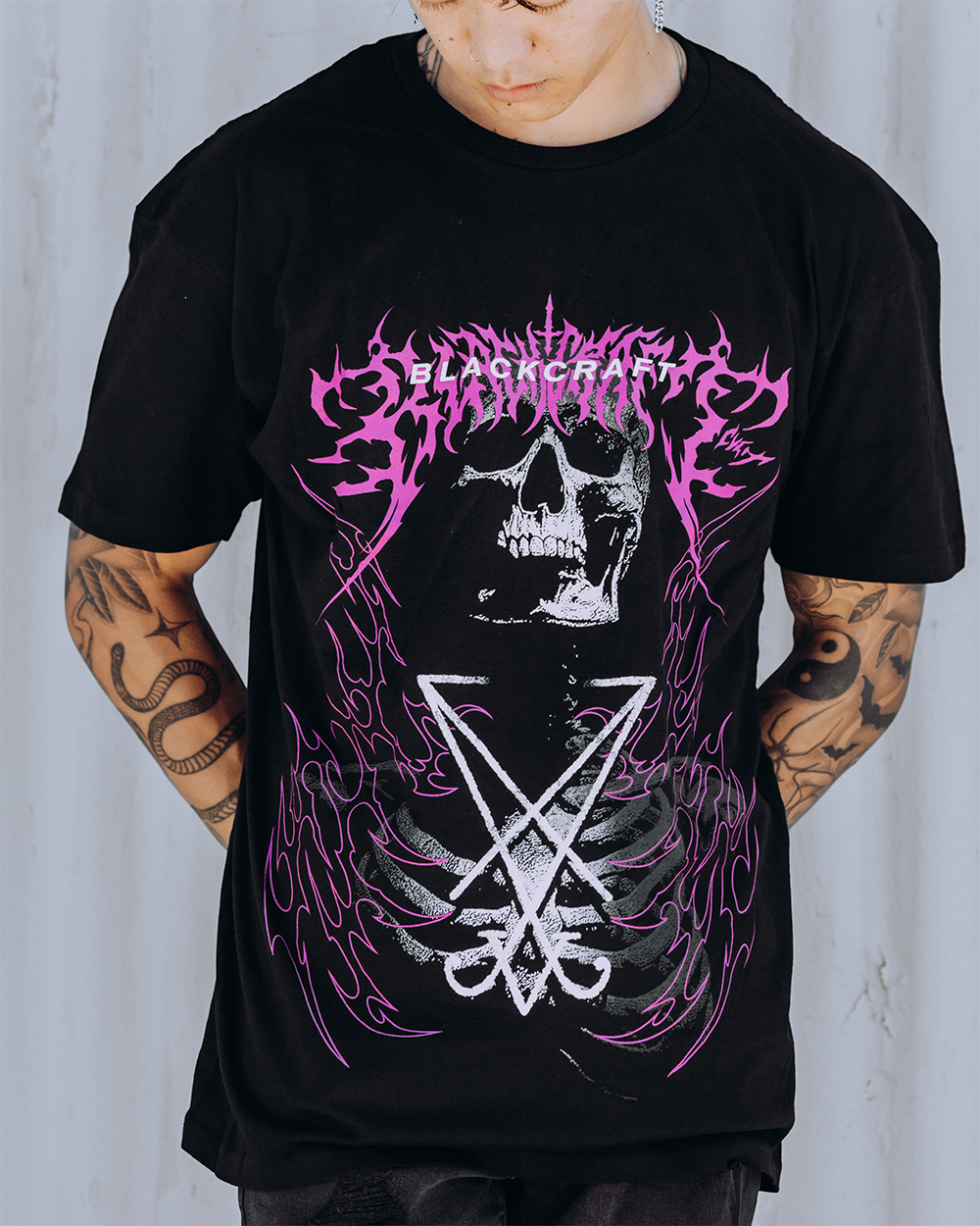 A model wearing a classic black cotton tee with custom Blackcraft artwork across the front. 