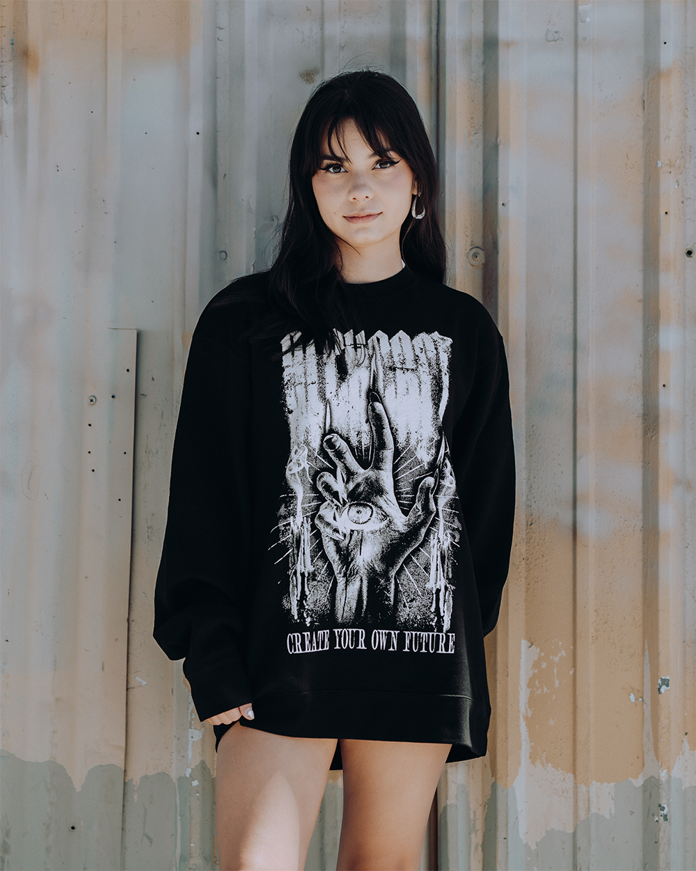 A model wearing a classic black sweatshirt with custom Blackcraft artwork on the front. 