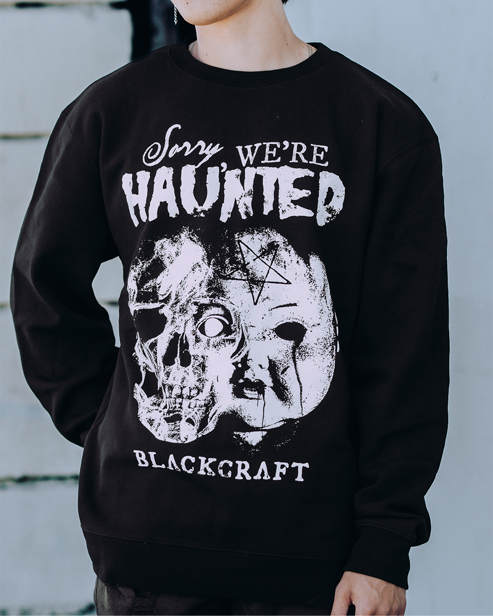 A model wearing a classic black sweatshirt with custom Blackcraft artwork on the front. 