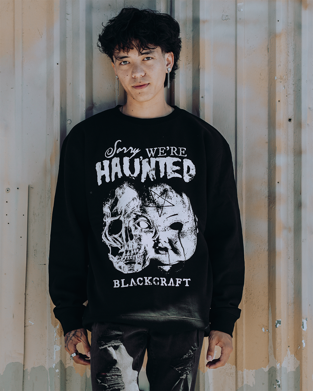 A model wearing a classic black sweatshirt with custom Blackcraft artwork on the front. 