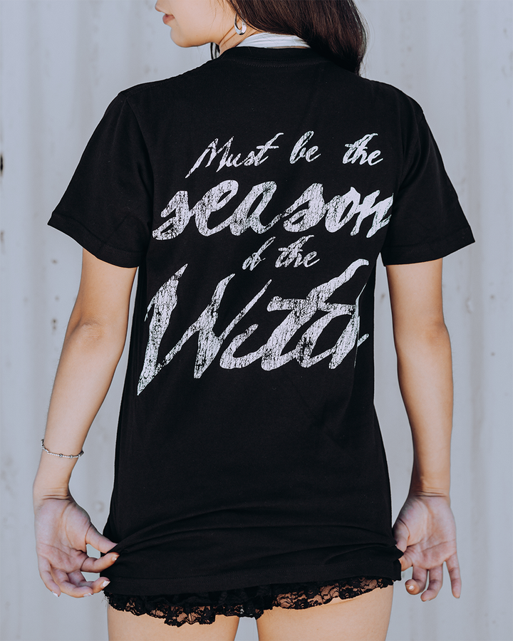 A model wearing a classic black cotton tee with custom Blackcraft artwork across the front and back. 