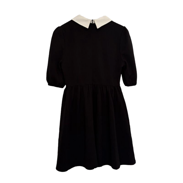 Black dress with a white collar on a white background