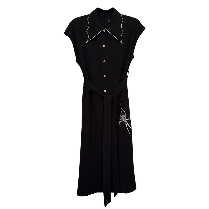 A classic black shirt dress with a spider web inspired collar with contrast white trim, an embroidered spider detail, a button front, short sleeves, and an adjustable waist tie. 