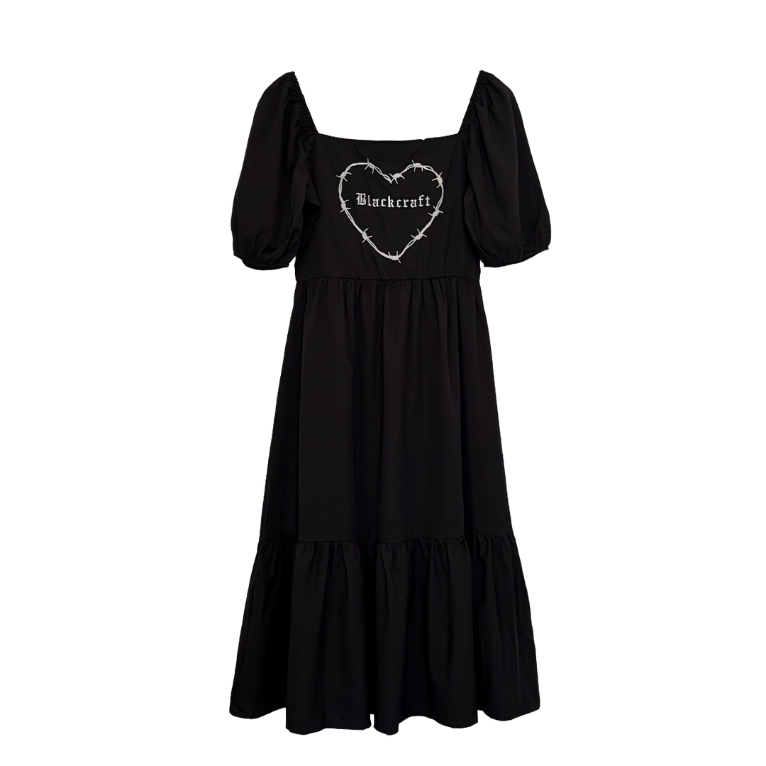 A black gothic maxi dress with short puff sleeves, a long flowy tiered skirt, and a half smocked bodice at the back for a slim fit.
