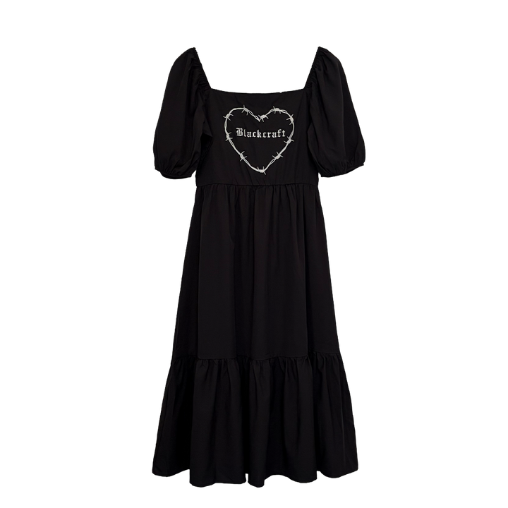 A black gothic maxi dress with short puff sleeves, a long flowy tiered skirt, and a half smocked bodice at the back for a slim fit.