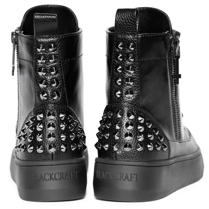 An all black sneaker boot with studded accents.