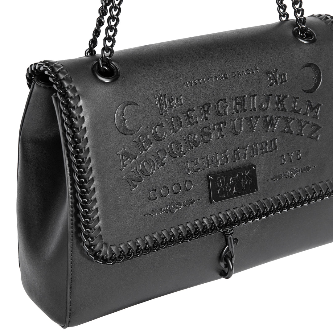 Black PU leather flap shoulder bag with adjustable drop strap and embossed Ouija design.