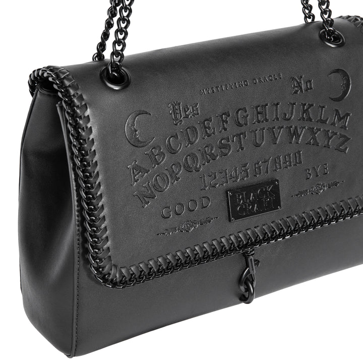 Black PU leather flap shoulder bag with adjustable drop strap and embossed Ouija design.