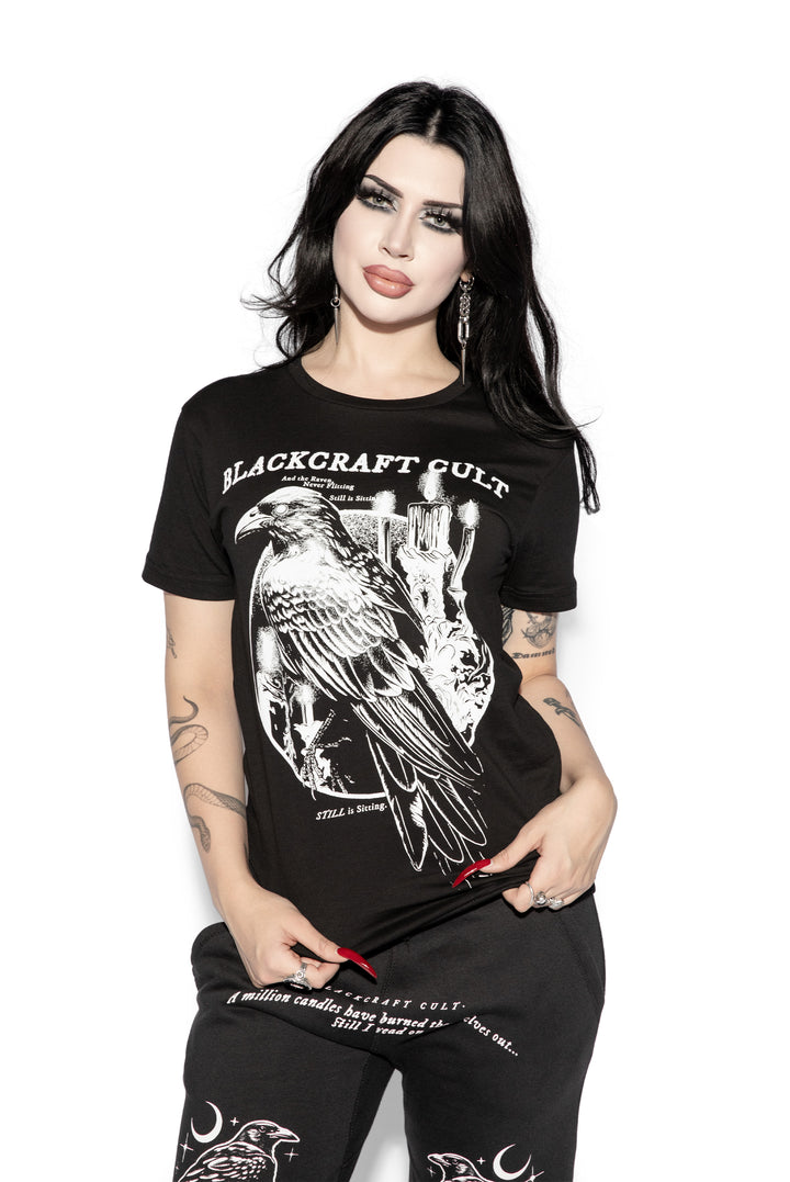 A model wearing a classic black cotton tee shirt with custom Blackcraft artwork on the front. 