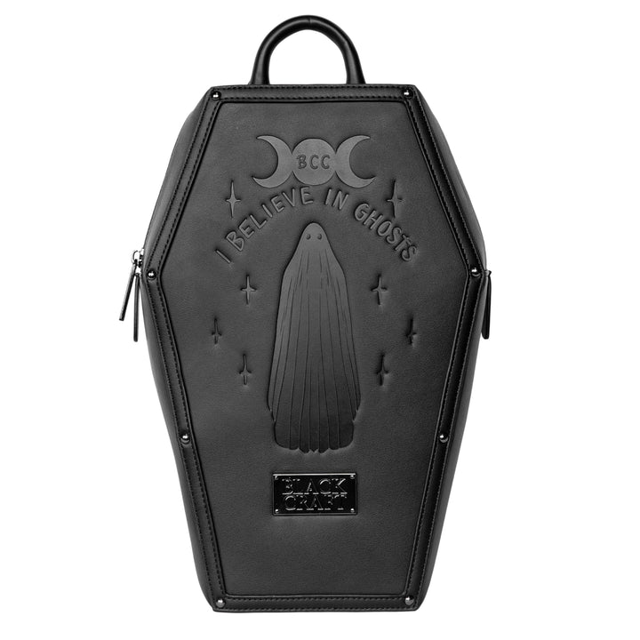Black faux leather coffin shaped backpack with I Believe in Ghosts Stories art embossed on front.