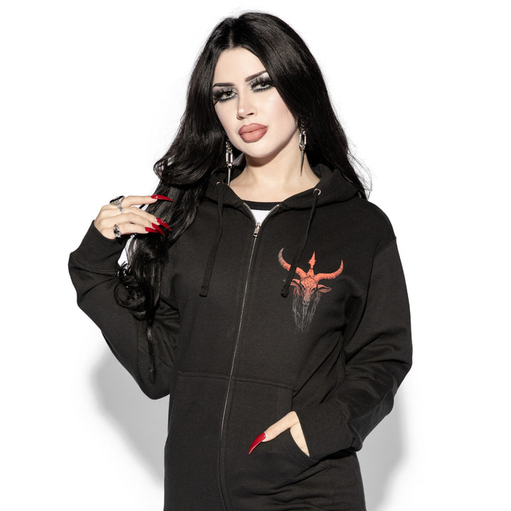 A brunette model wearing a classic black zip up hoodie with custom devil artwork on the front and back.