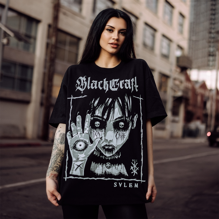 A model wearing a black oversized boxy tee with custom Blackcraft artwork on the front. 