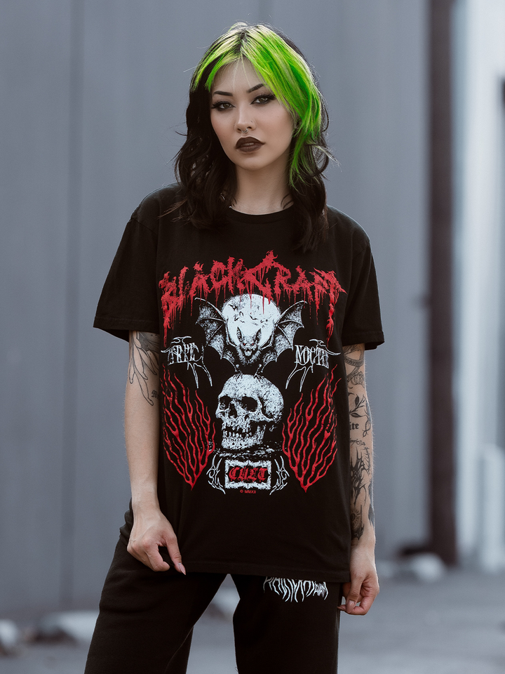 A green haired model wearing a classic black cotton tee with custom Blackcraft artwork across the front. 