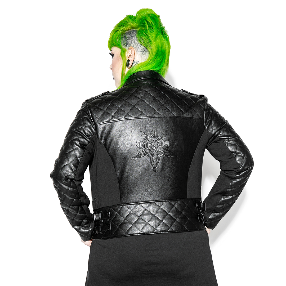 A green haired model wearing a classic black faux leather jacket from Blackcraft.