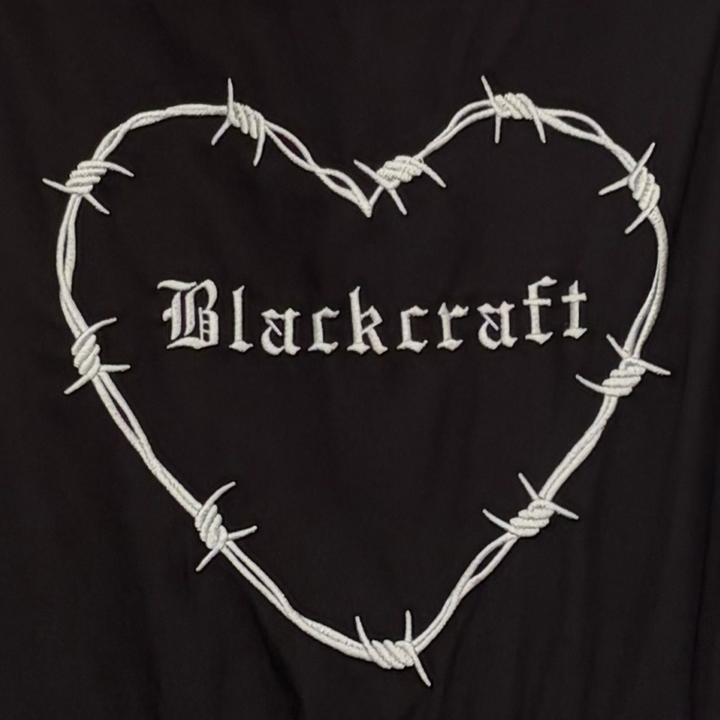 A black gothic maxi dress with short puff sleeves, a long flowy tiered skirt, and a half smocked bodice at the back for a slim fit.