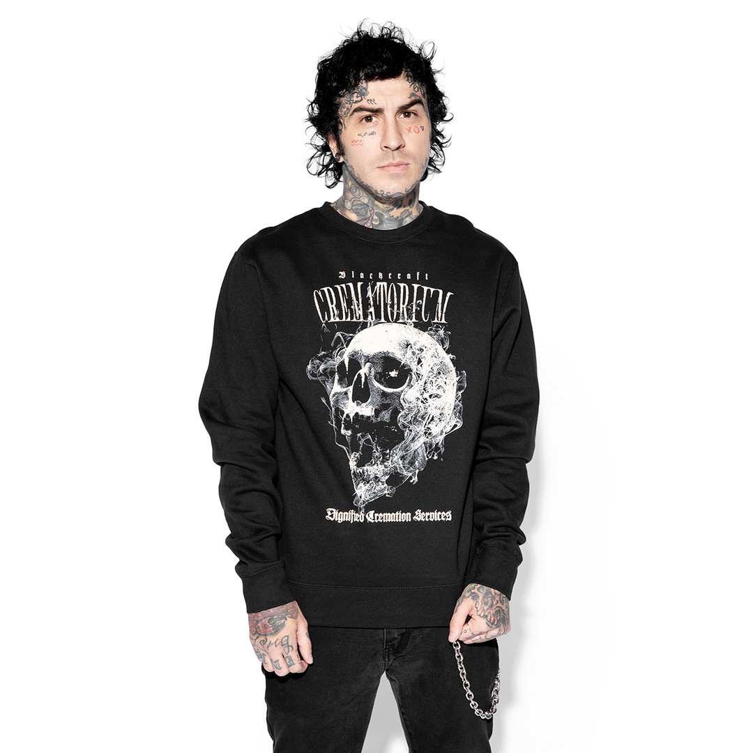 A model wearing a black pullover sweatshirt with custom Blackcraft artwork.
