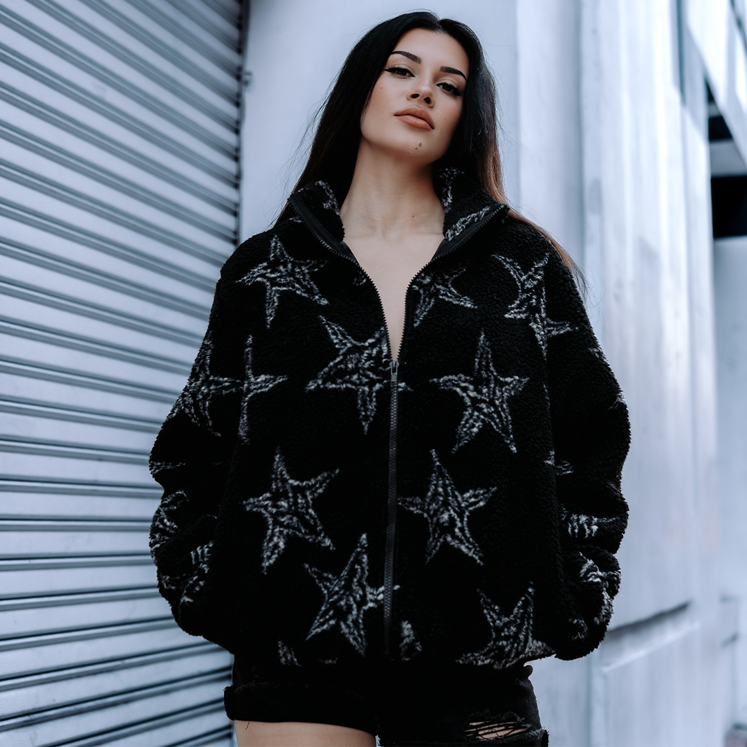 A model wearing a relaxed fit zip up fleece made from ultra soft and cozy fleece. Featuring an allover Baphomet print.