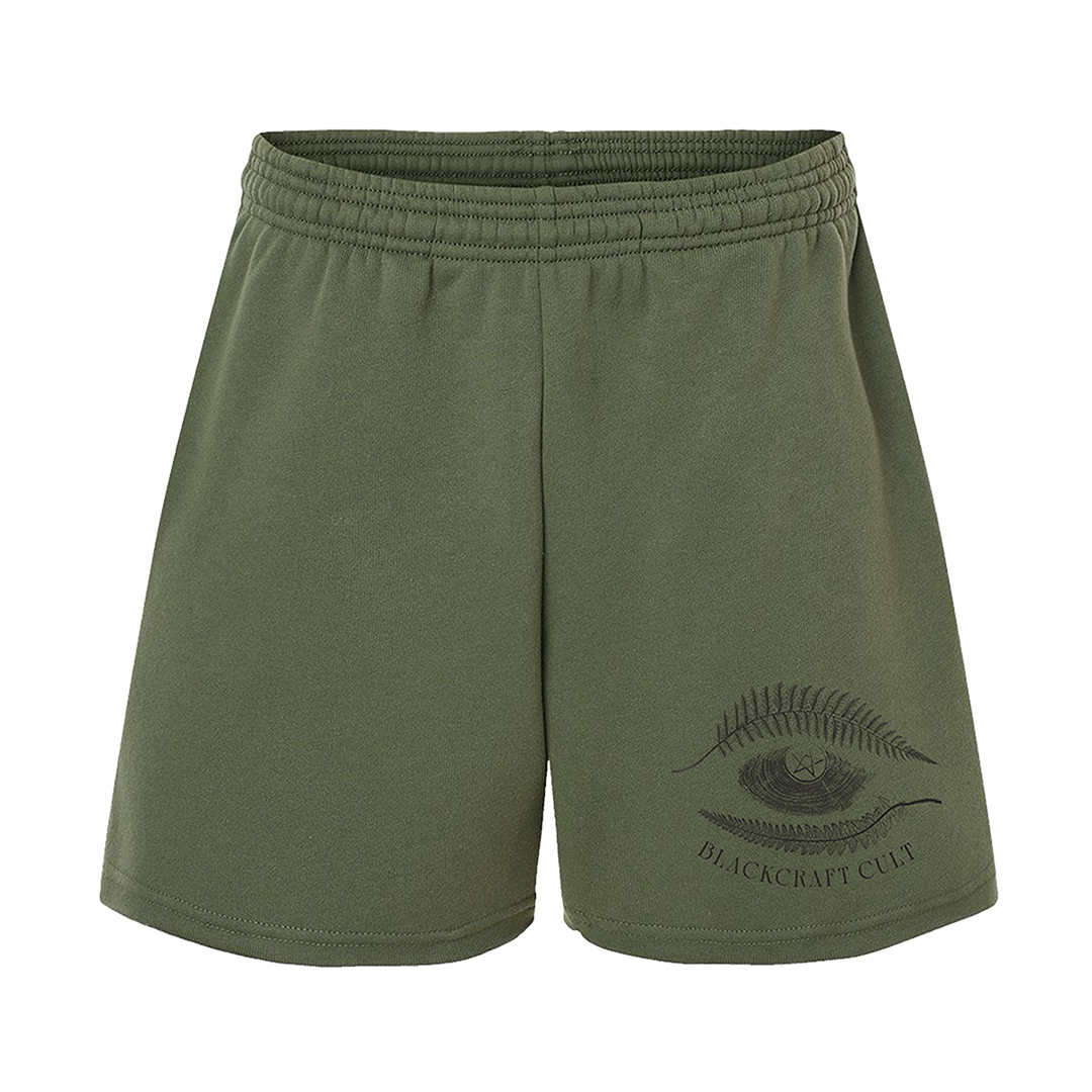 Military green Blackcraft sweat shorts with custom plant witch artwork on the front thigh.