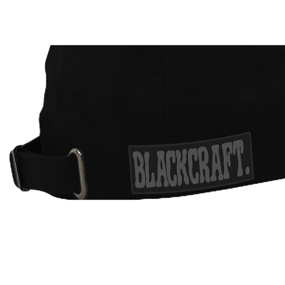 A classic black hat featuring metal stud accents and printed grey flame details along the brim.