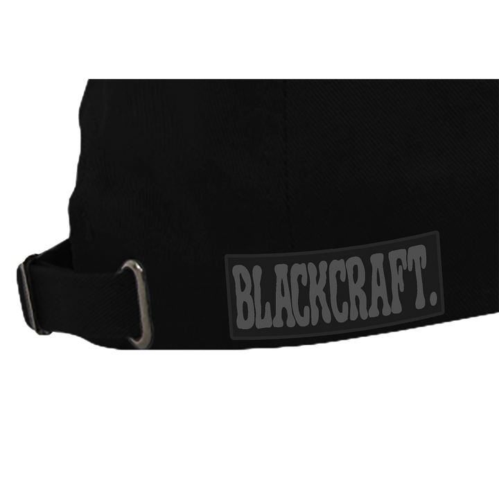 A classic black hat featuring metal stud accents and printed grey flame details along the brim.