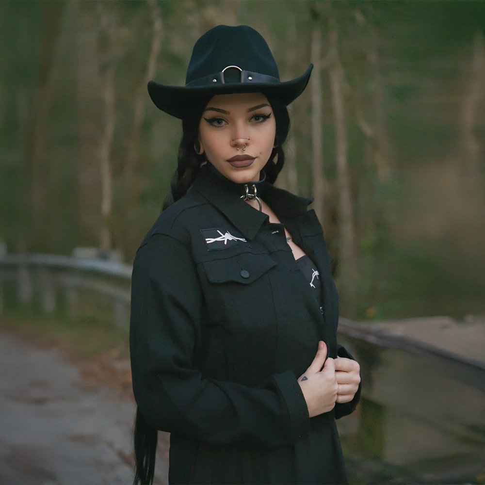 A classic black denim jacket with embroidered barbed wire heart design at the back.