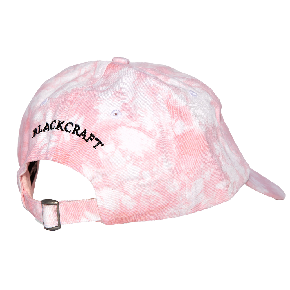 A classic pink tie dye cotton twill hat with embroidered design on the front.