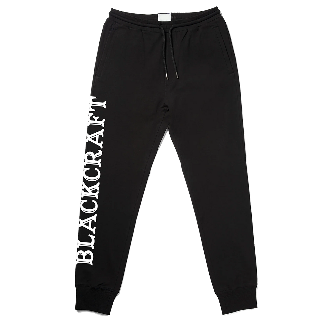 Classic black Womens joggers with custom Blackcraft artwork along the side of the leg. 