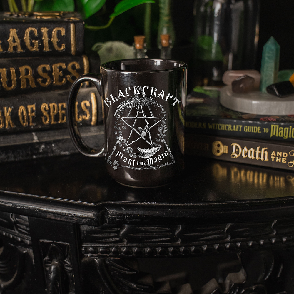 A large glossy black fifteen ounce mug with custom plant witch artwork on the front. From Blackcraft.