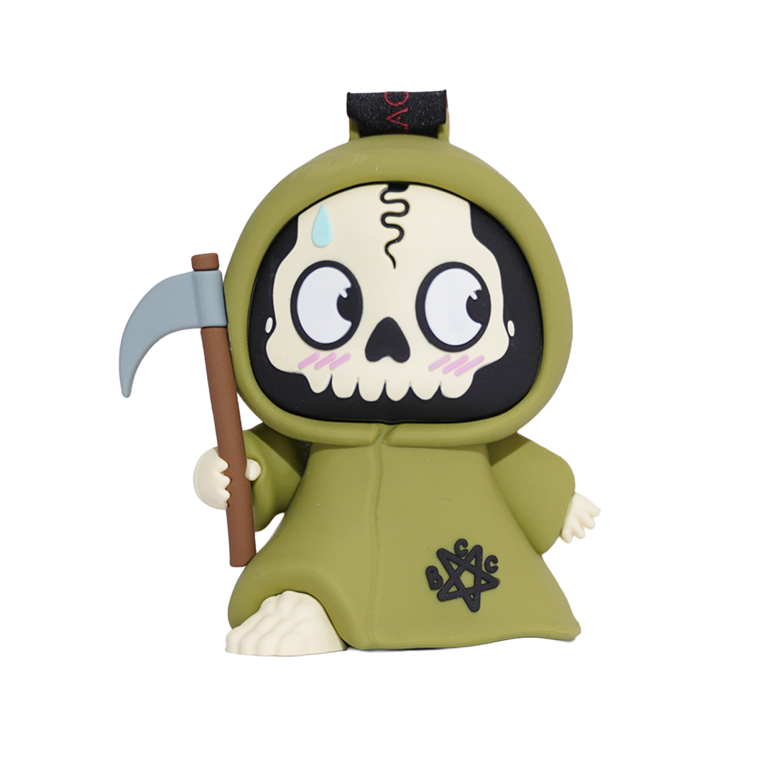 A cartoon Grim Reaper figurine featuring a cute, stylized design with a green hooded robe, a skull face, and a scythe.