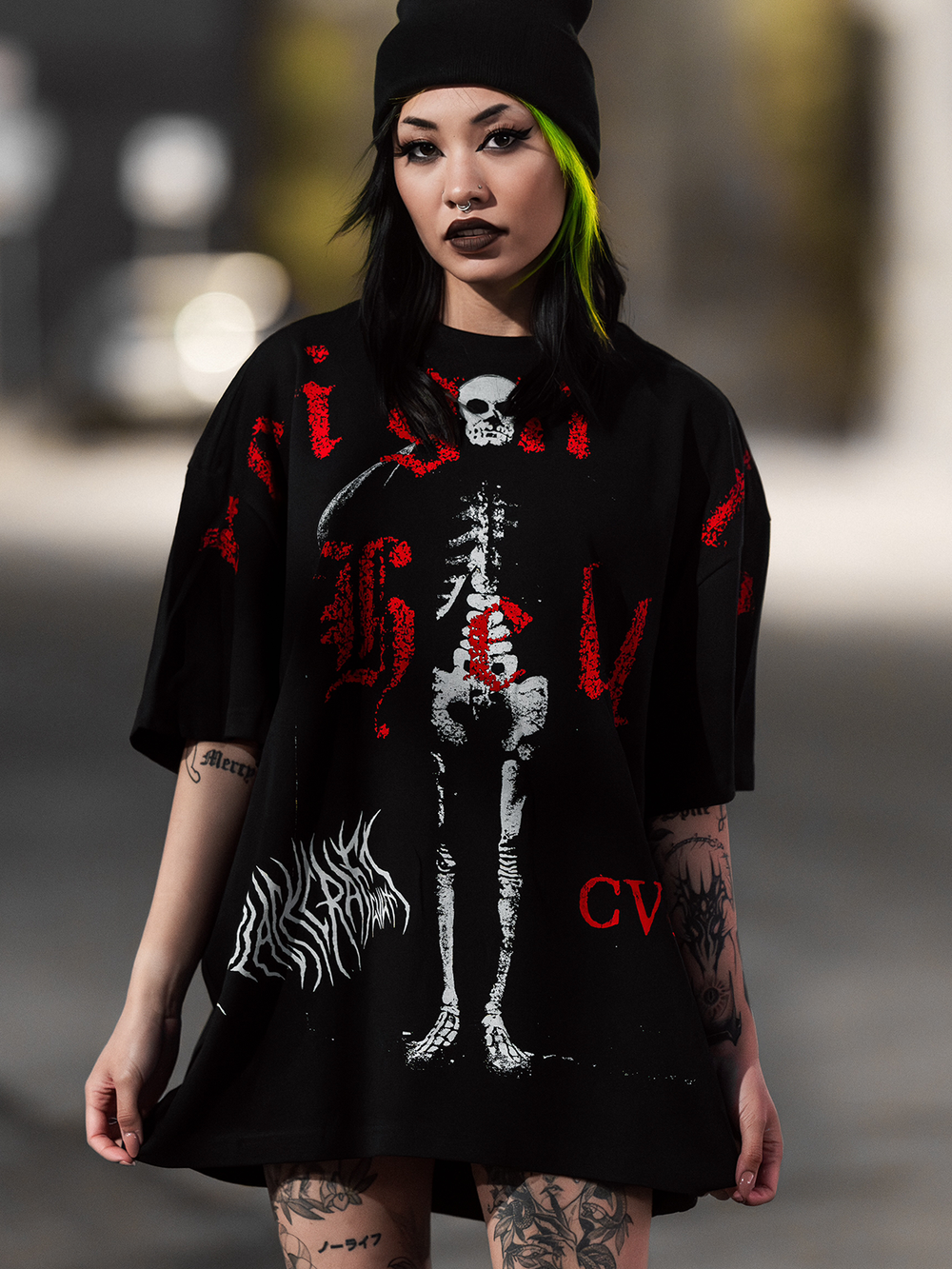 A model standing outside wearing an oversized black tee with custom Blackcraft artwork on the front. 