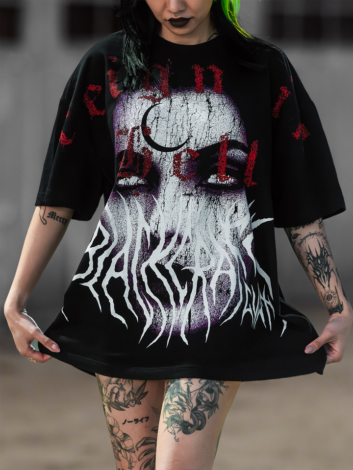 A model standing outside wearing an oversized black tee with custom Blackcraft artwork on the front. 