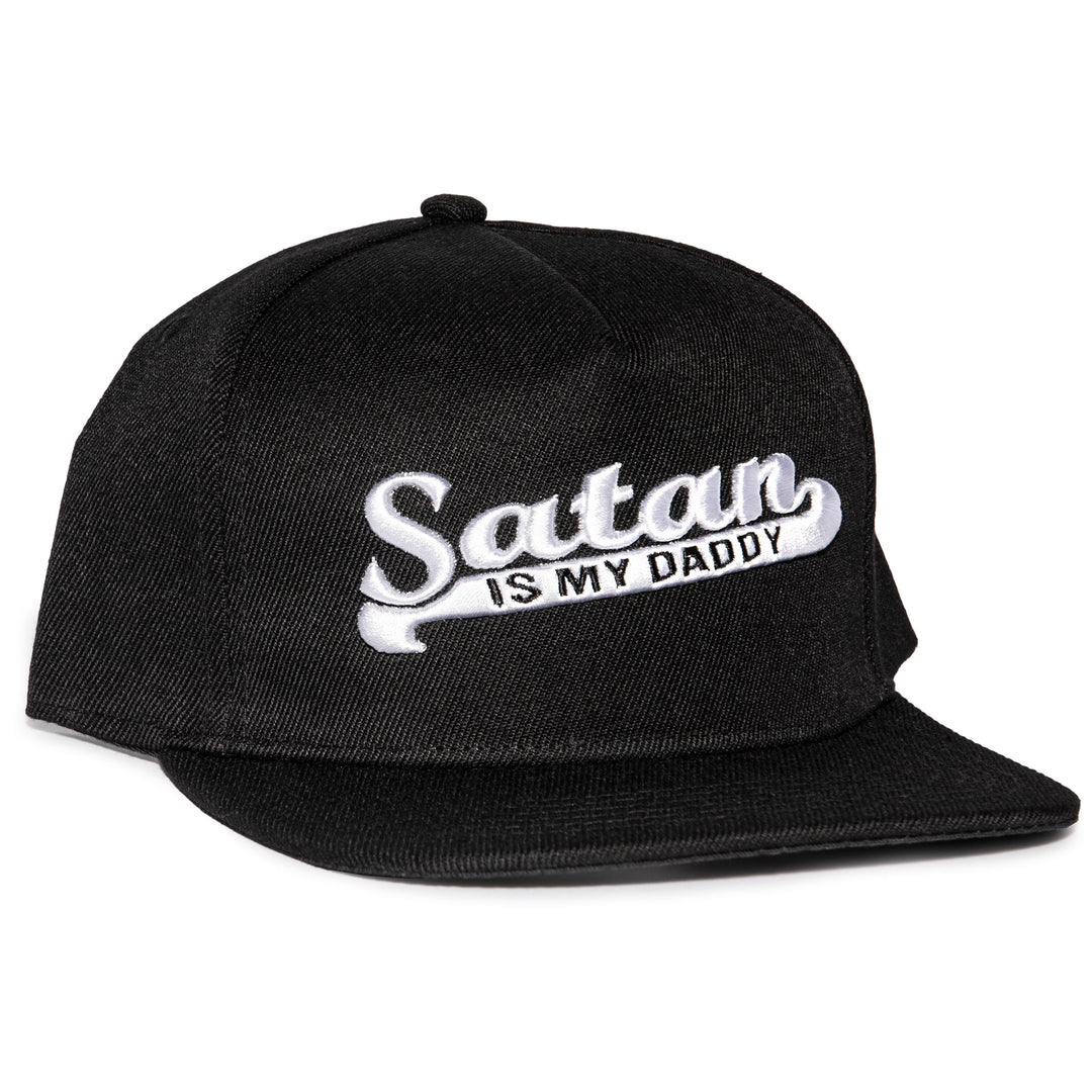 A black snapback hat with white embroidered Satan is my Daddy on the front. 