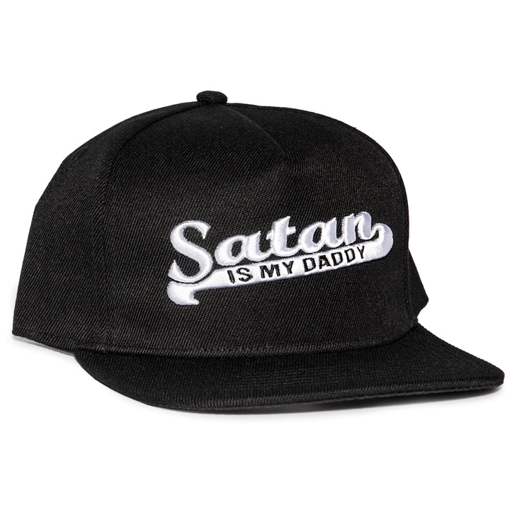A black snapback hat with white embroidered Satan is my Daddy on the front. 