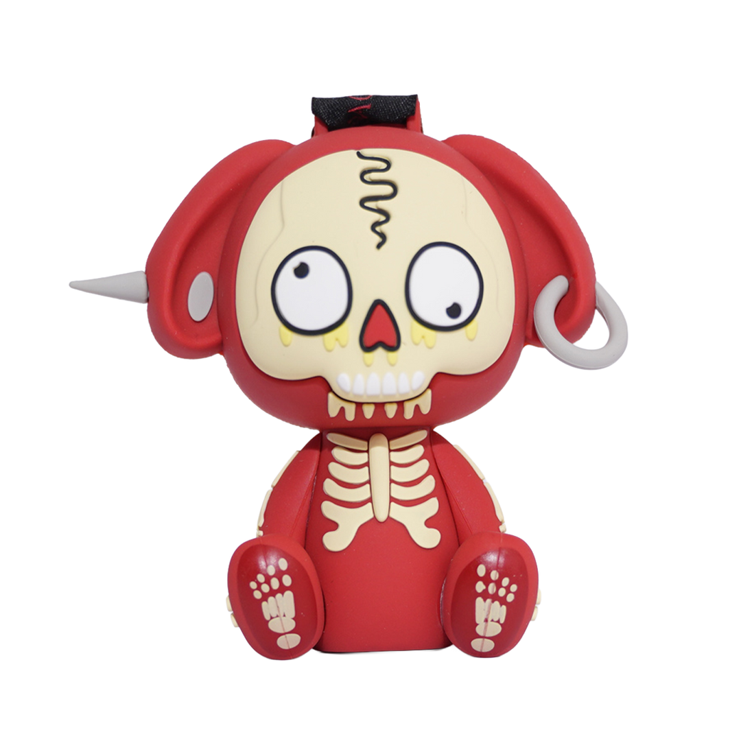 A red and cream-colored cartoon skull figurine with large white eyes, a black top detail, and small white side protrusions.