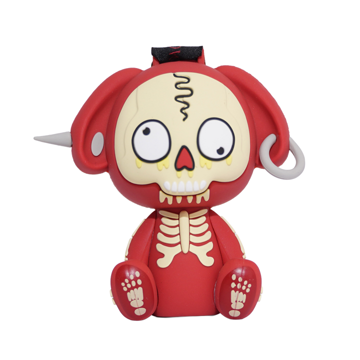 A red and cream-colored cartoon skull figurine with large white eyes, a black top detail, and small white side protrusions.