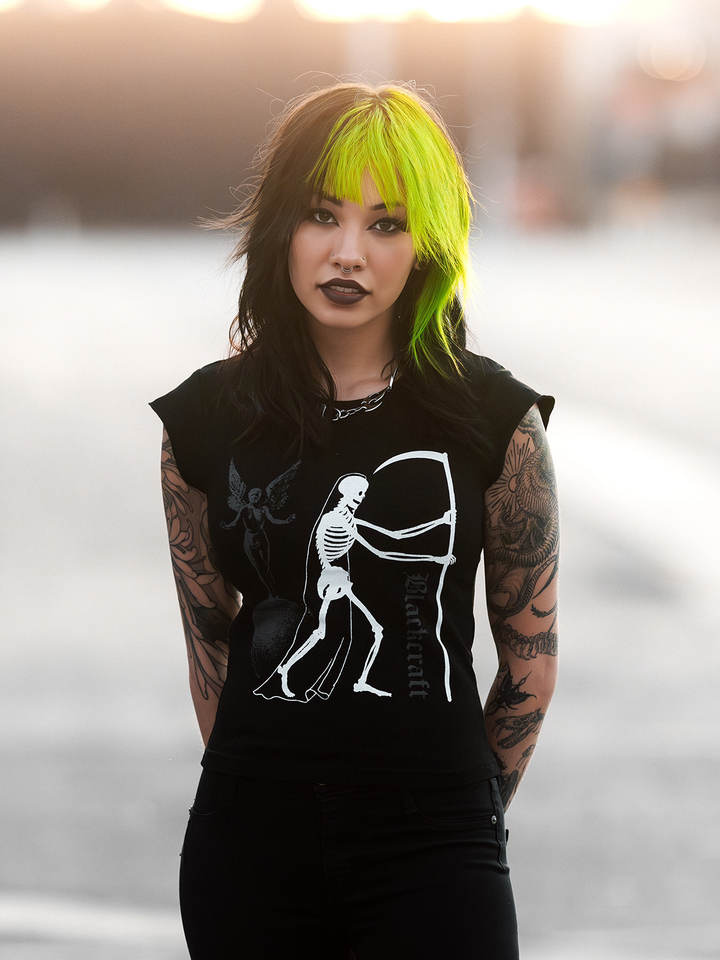 A model standing outside wearing a black cropped tee with custom Blackcraft artwork on the front. 