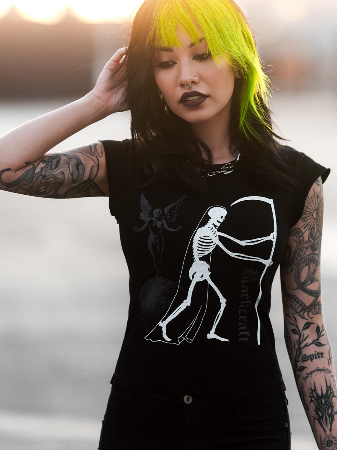A model standing outside wearing a black cropped tee with custom Blackcraft artwork on the front. 