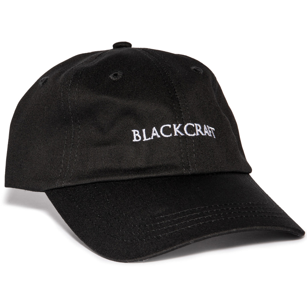 A black washed cotton dad hat with embroidered Blackcraft logo on the front.