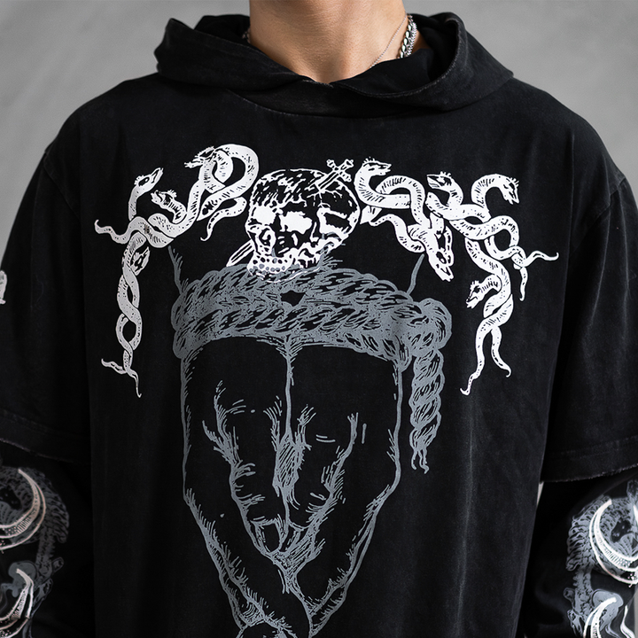 A model wearing a washed black long sleeve twofer pullover hoodie with custom Blackcraft artwork on the front and along the sleeves.