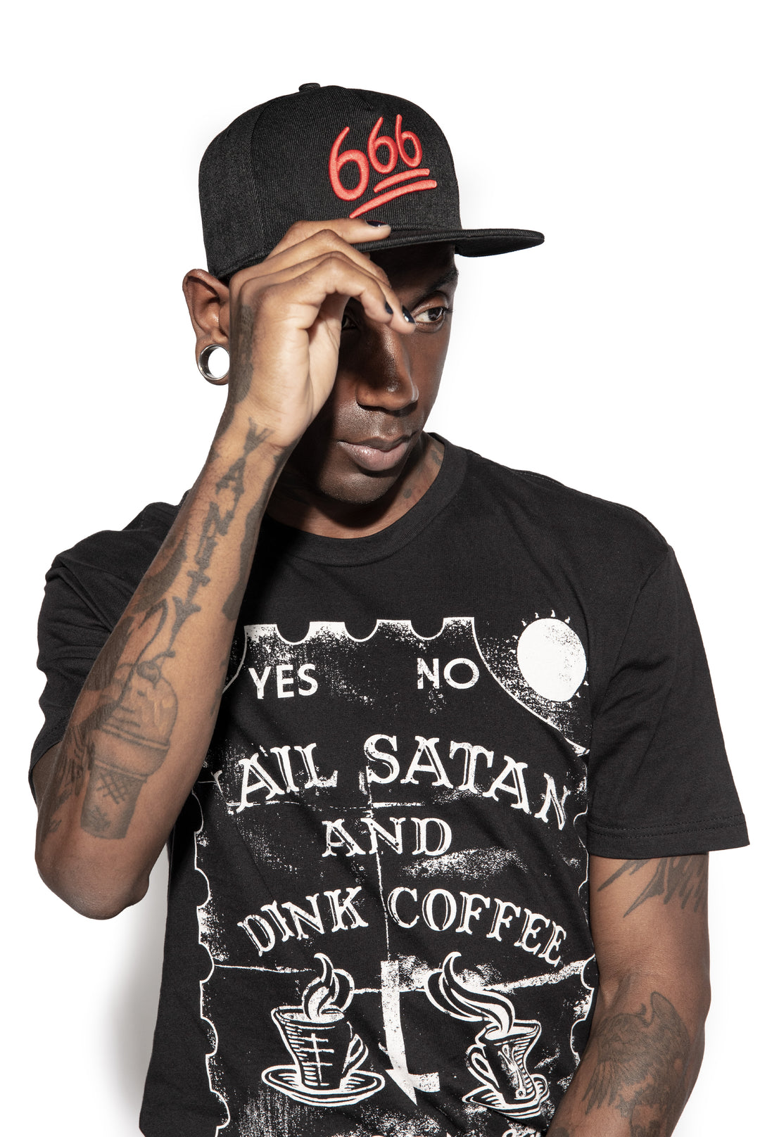 A model wearing a black snapback hat with red embroidered 666 on the front. 