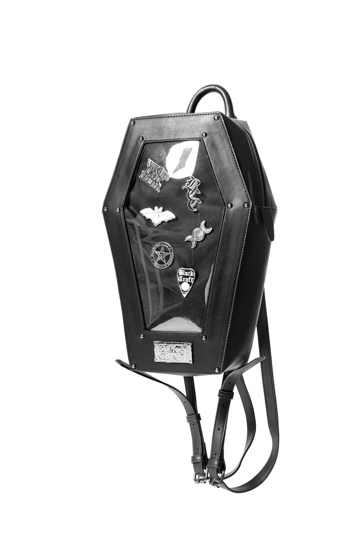Black faux leather coffin shaped backpack with a Pin Collecting Window. 