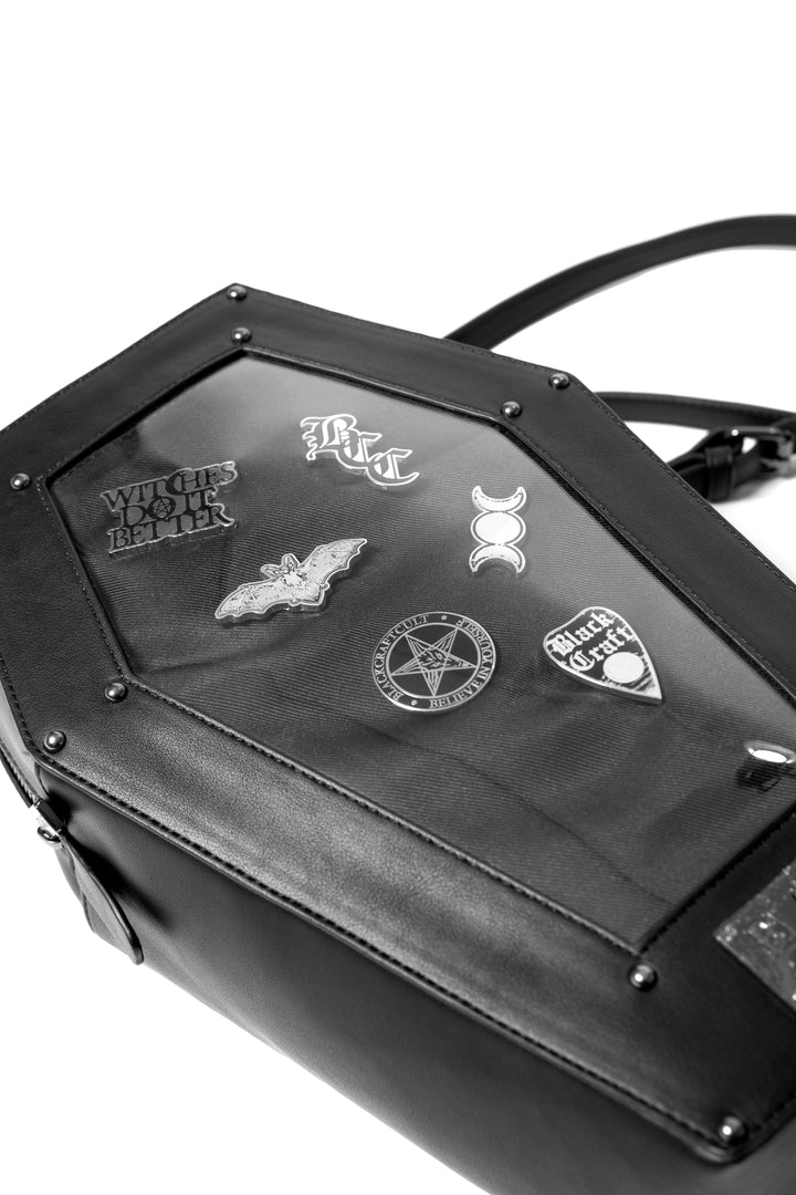 Black faux leather coffin shaped backpack with a Pin Collecting Window. 